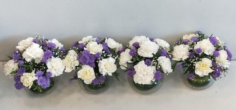 Table Arrangement with Beautiful Carnations and Blue Daisy in Glass Vase