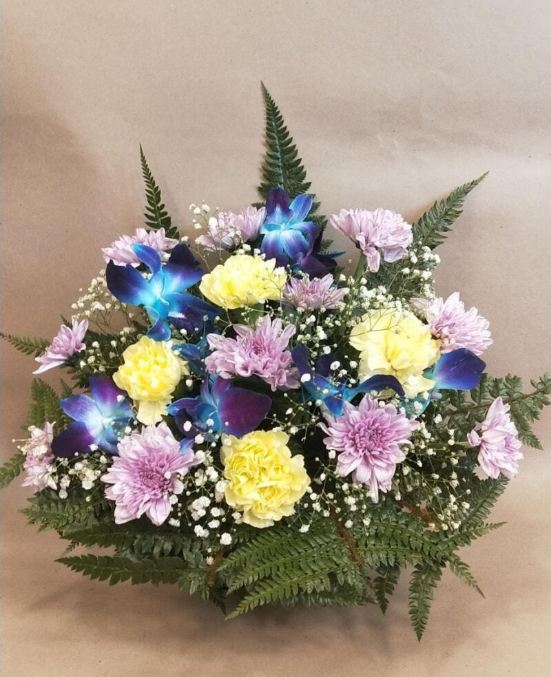 Floral Arrangement made with Spray Daisies, Carnations and Orchids in Glass Vase